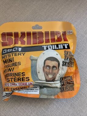 Skibidi Toilet Mystery Mini Figures - Yellow Orange Packaging